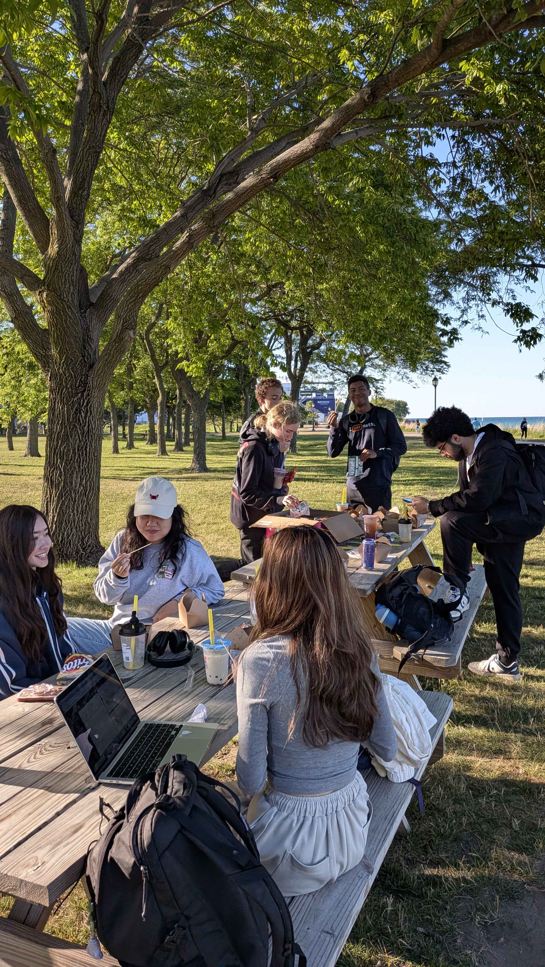 FutureDev members hanging out together at a picnic table outside