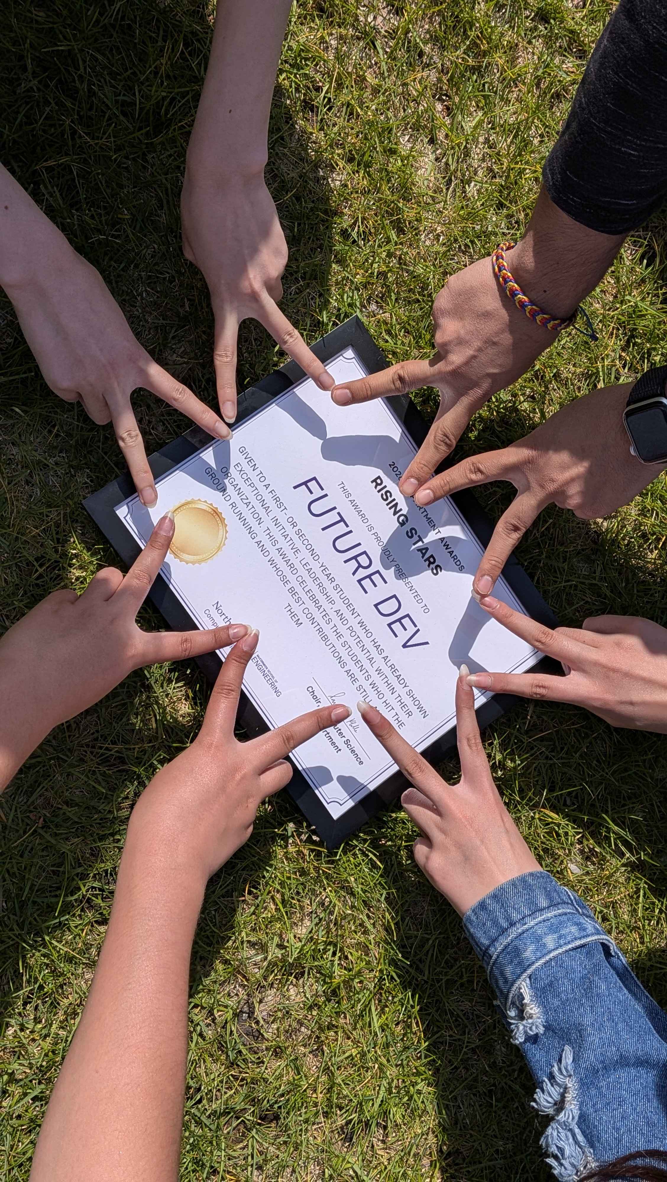 FutureDev members' hands framing the club's Northwestern CS Department Rising Stars award